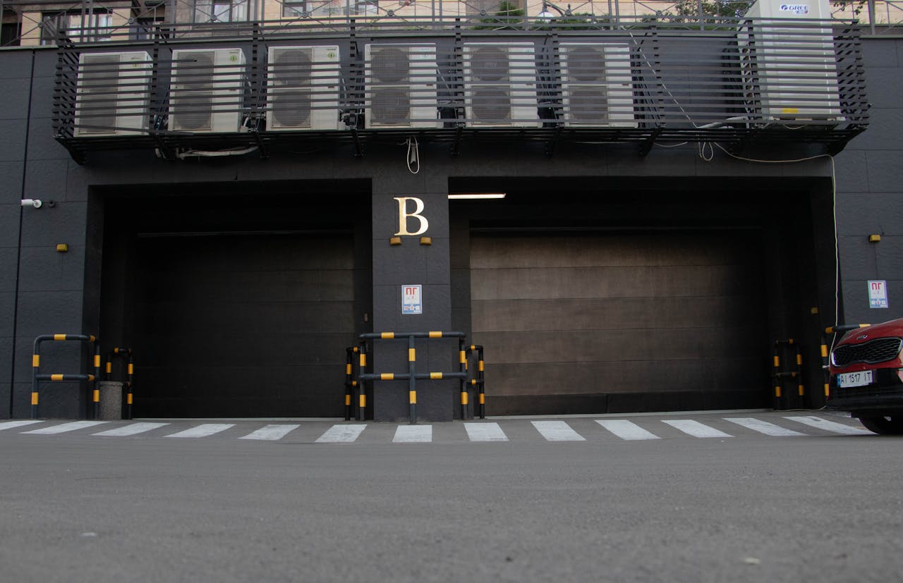 Services Modern garage entrance with air conditioning units above and a zebra crossing in Kyiv, Ukraine.